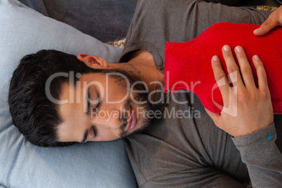 Man sleeping with hot water bag