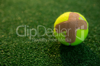 Close up of tennis ball with bandage