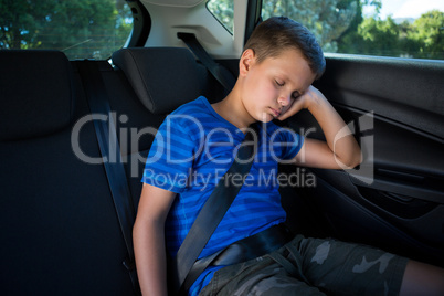 Teenage boy sleeping in the car
