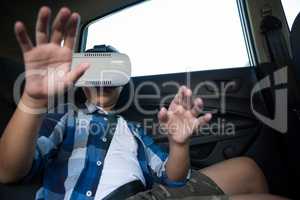 Teenage boy using virtual reality headset in the car