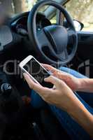 Woman using mobile phone in the car