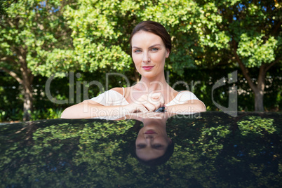 Beautiful woman leaning on a car