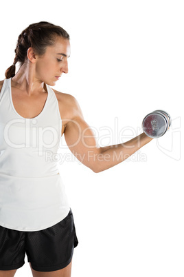 Young female rugby player lifting dumbbell