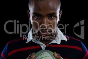 Close up portrait of sportsman holding rugby ball