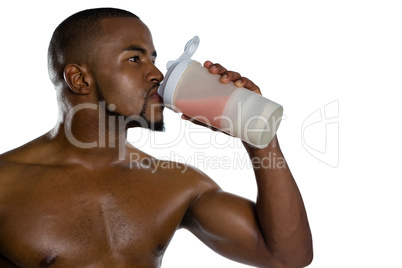 Close up of shirtless sportsman having energy drink