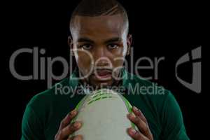 Close up portrait of confident male athlete with rugby ball