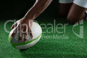 Close up of sportsman holding rugby ball