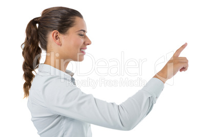 Female executive pressing an invisible virtual screen