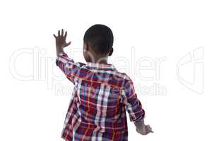 Boy pretending to touch an invisible screen against white background