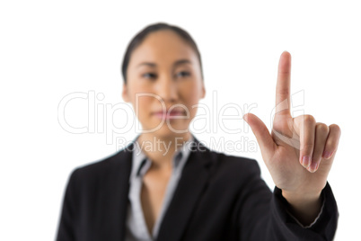 Businesswoman pressing an invisible virtual screen