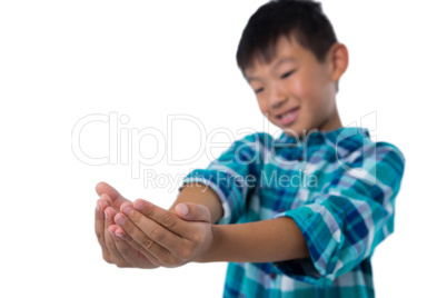 Boy pretending to hold invisible object