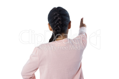 Girl pretending to touch an invisible screen against white background