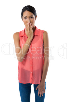 Woman covering her mouth with hand against white background