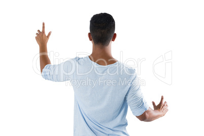 Man pretending to touch an invisible screen against white background