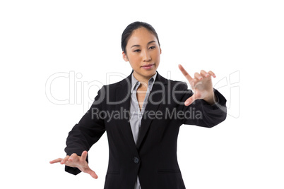 Businesswoman pressing an invisible virtual screen