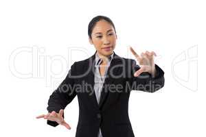 Businesswoman pressing an invisible virtual screen