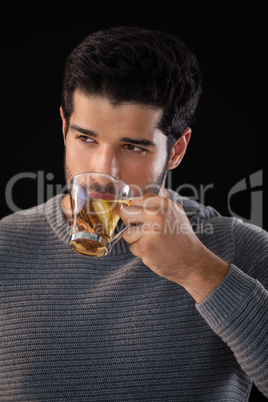 Thoughtful man having a cup of lemon tea