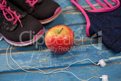 High angle view of womenswear with apple and headphones