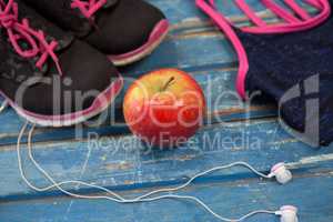 High angle view of womenswear with apple and headphones