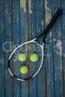 Overhead view of tennis racket and balls