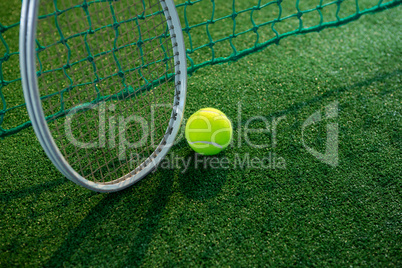 High angle view of tennis ball with racket by net