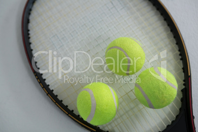 Close up of fluorescent yellow tennis ball on racket
