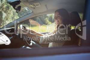 Smiling woman driving a car