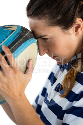 Side view of female player with rugby ball