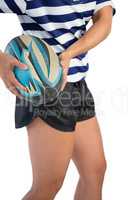 Mid section of female athlete with rugby ball