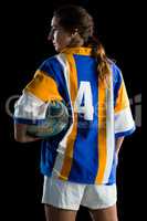 Rear view of female rugby player holding ball