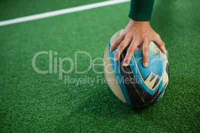 Cropped hand of woman holding rugby ball