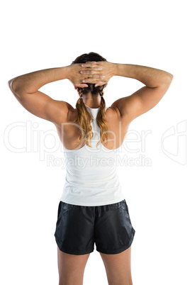Rear view of female athlete with hands behind head