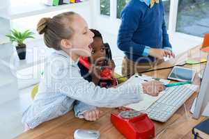 Boy as business executive talking on phone