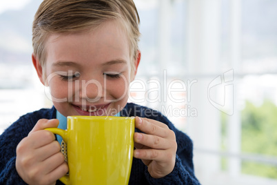 Boy as business executive holding coffee mug