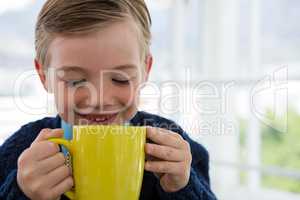 Boy as business executive holding coffee mug