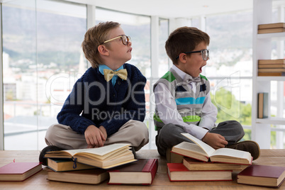 Kids as business executive sitting on a table