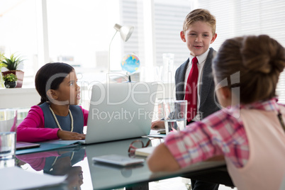 Kids as business executives interacting while meeting