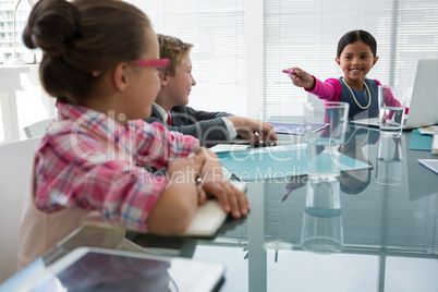 Kids as business executives interacting while meeting