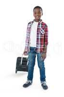 Portrait of smiling boy standing with suitcase