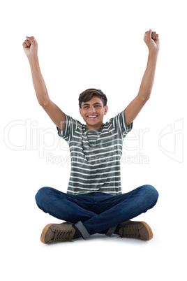 Teenage boy exercising against white background