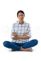 Worried woman sitting with arms crossed