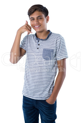 Teenage boy pretending to talk on a cell phone