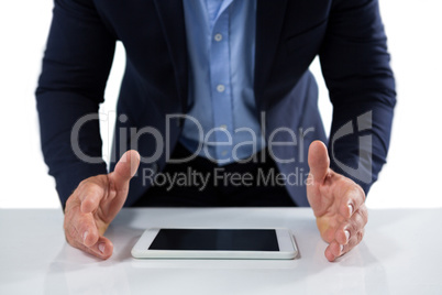 Businessman trying to hold the digital tablet