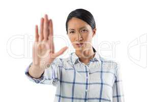 Woman showing stop sign against white background