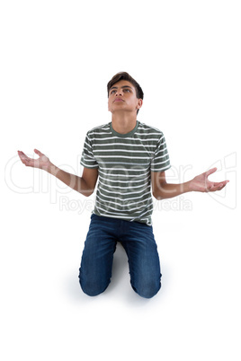 Worried teenage boy praying