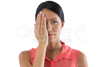 Woman covering her eye with hand against white background
