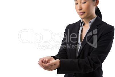 Smiling businesswoman with hand cupped against white background