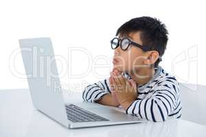Boy using laptop against white background