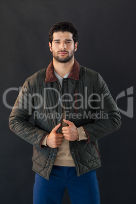 Man posing against black background