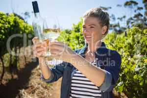 Female vintner examining wine